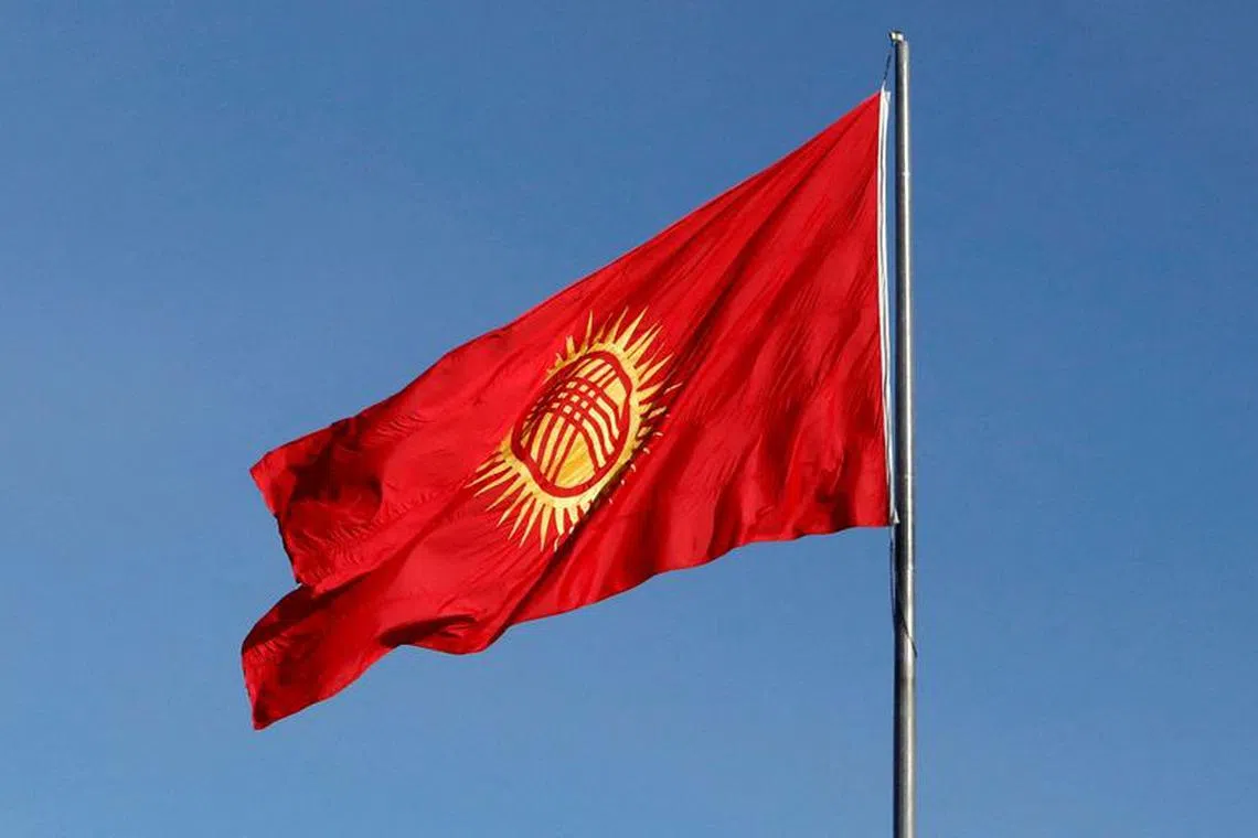 FILE PHOTO: A view shows the renewed Kyrgyz national flag, following the state parliament decision to tweak its design after critics said its central element including wavy rays looked like a sunflower which in the local culture symbolises fickleness and servility, during a ceremony in Bishkek, Kyrgyzstan, January 1, 2024. REUTERS/Vladimir Pirogov/File Photo