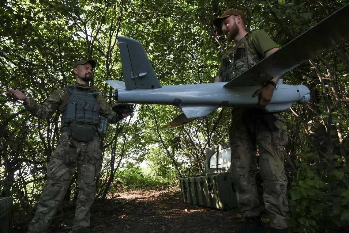 Ukrainian servicemen prepare a reconnaissance drone for flight, in Ukraine's Donetsk region.