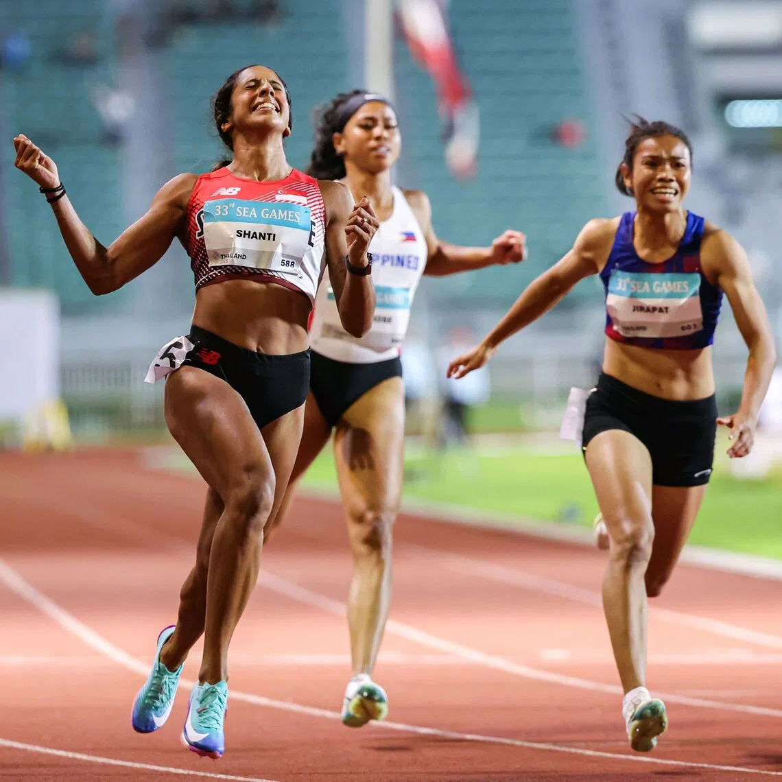 Singapore’s sprint queen Shanti Pereira raising her arms in ecstasy after retaining the women’s 100m title in 11.36sec at the Supachalasai National Stadium in Bangkok on Dec 11, with Thailand’s Khanonta Jirapat (in blue, 11.54) second and Vietnam’s Ha Thi Thu (not in picture, 11.58) third. Pereira went on to secure a historic double-double by winning the 200m two days later.