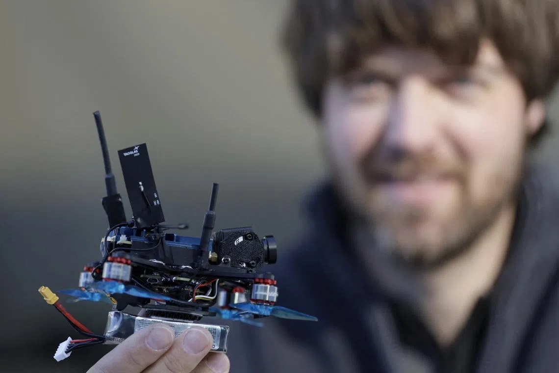 Dutch drone pilot Ralph Hogenbirk holds a FPV drone, used for capturing action in the sliding center, during an interview with Reuters in Cortina d'Ampezzo, Italy, February 13, 2026. REUTERS/Leonhard Foeger