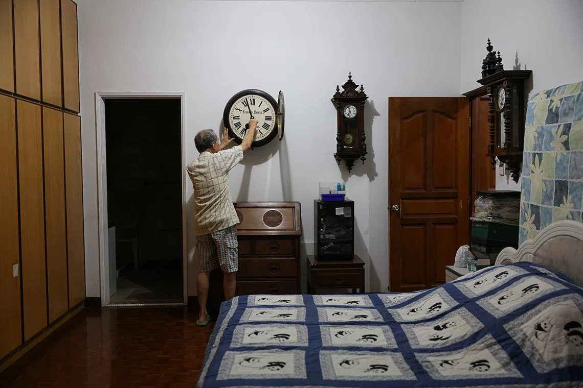 ST20240407_202415406861: Gin Tay/ gtclock/Ang Qing/  Mr Mun Chor Weng, 83, winding The Europe Hotel Clock in his bedroom on every Sunday morning between 6.30 am to 7am. Mr Mun has a Sunday winding habit that can be traced to his teenage years helping his dad to wind up all the clocks in the shop. Most if not all the clocks in the shop run for 7 days. Even after Mr Mun relocated with the clocks, he continued with the Sunday ritual and made it a point to wind the clock when he wakes up around 6.30 to 7am.