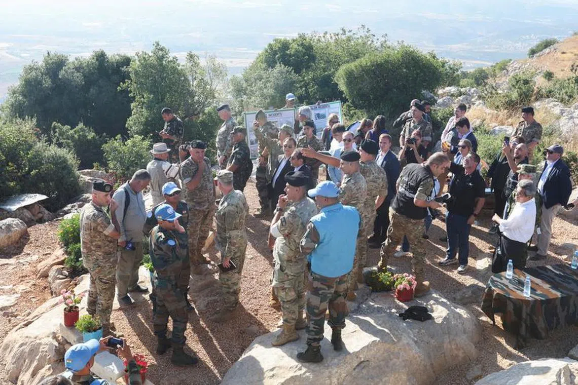 FILE PHOTO: Members of the Lebanese army and UN peacekeepers (UNIFIL) stand together during Lebanese army media tour in disputed Bastra farms, near the border with Israel, in southern Lebanon, August 8, 2023. REUTERS/Aziz Taher/File Photo