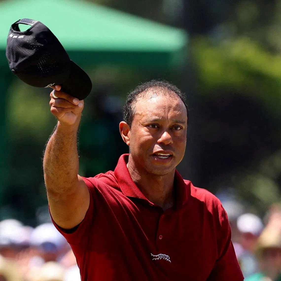 FILE PHOTO: Golf - The Masters - Augusta National Golf Club, Augusta, Georgia, U.S. - April 14, 2024 Tiger Woods of the U.S. acknowledges the crowd on the green on the 18th hole after completing his final round REUTERS/Mike Blake/File Photo