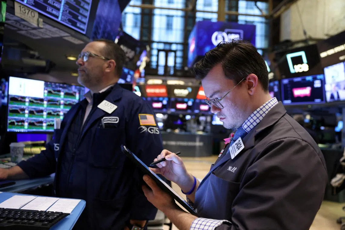 Traders work on the trading floor of the New York Stock Exchange, in New York City.