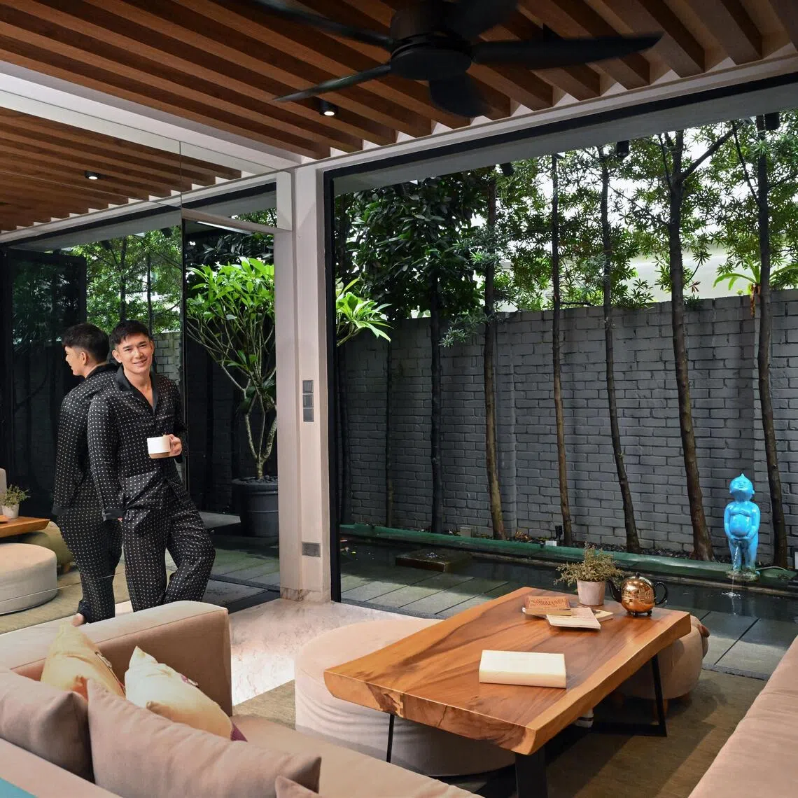 Actor Elvin Ng’s favourite spot in the house is a casual sitting area tucked beside a long koi pond and framed by greenery.