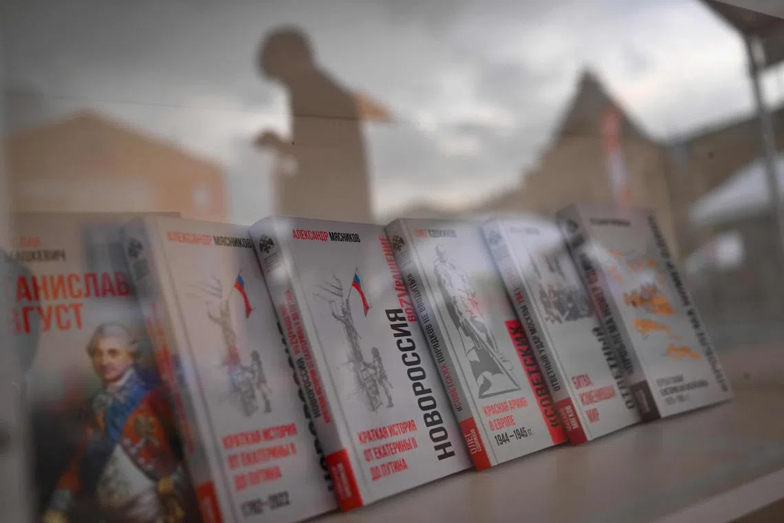 Patriotic books on shelves during the 10th edition of the "Red Square" book festival in Moscow on June 6, 2024. (Photo by Natalia KOLESNIKOVA / AFP)