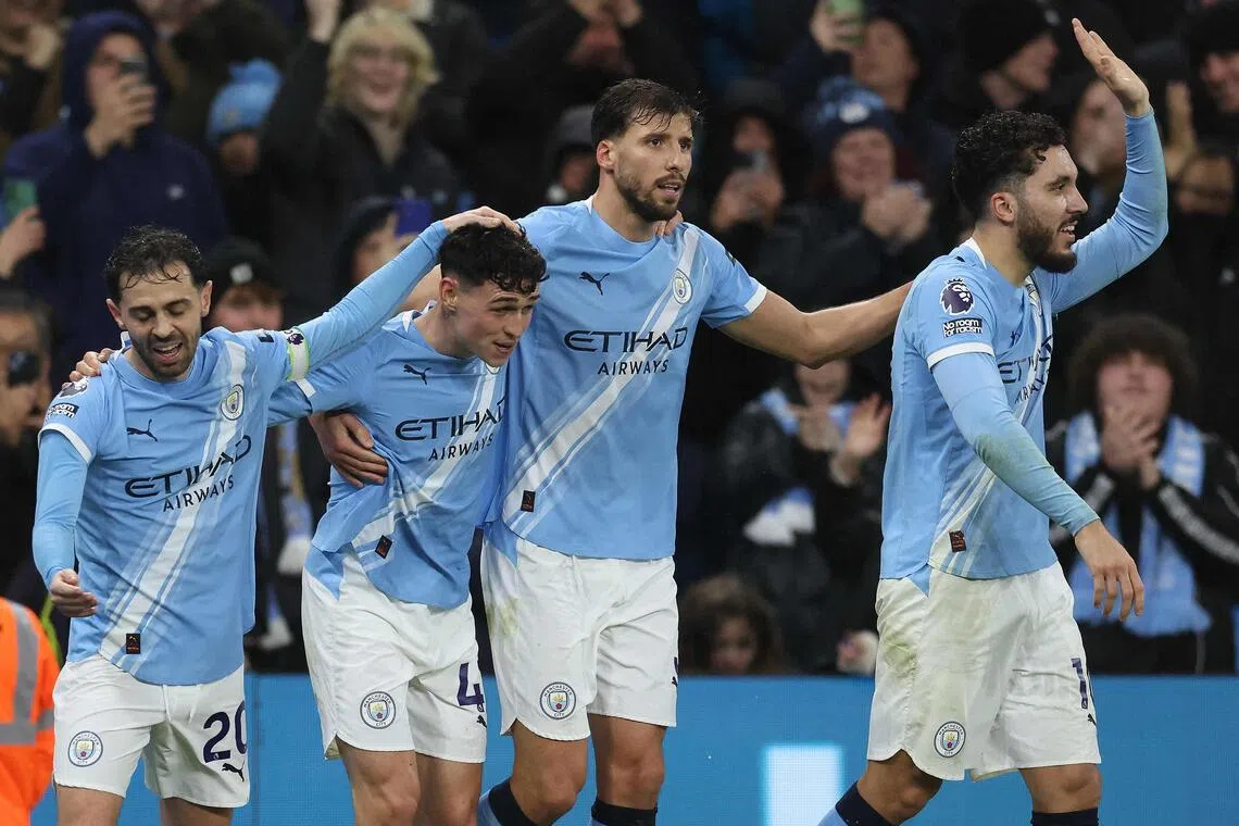 Midfielder Phil Foden (second from left) celebrates scoring Manchester City's third goal - his fifth in three games - with teammates Bernardo Silva, Ruben Dias and Rayan Cherki.