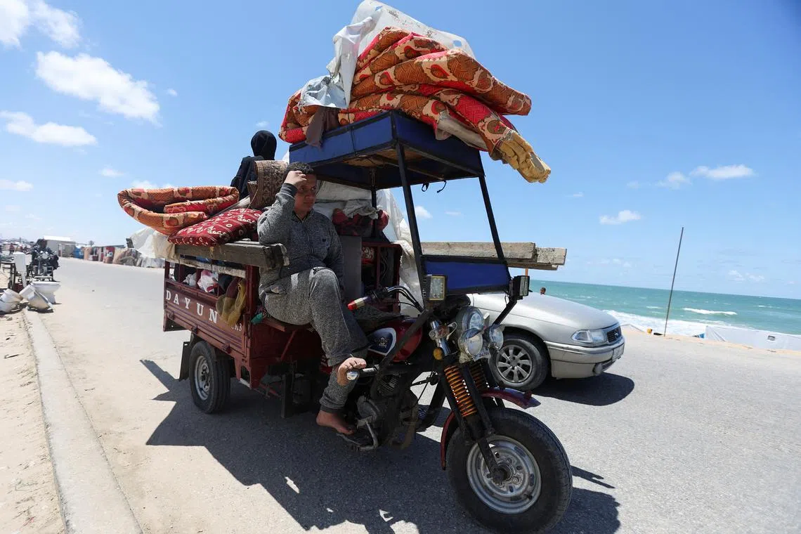 Displaced Palestinians, who fled Rafah after the Israeli military began evacuating civilians from the eastern parts of the southern Gaza city, ahead of a threatened assault, amid the ongoing conflict between Israel and Hamas, travel in the Al-Mawasi area, in Khan Younis in the southern Gaza Strip, May 6, 2024. REUTERS/Ramadan Abed