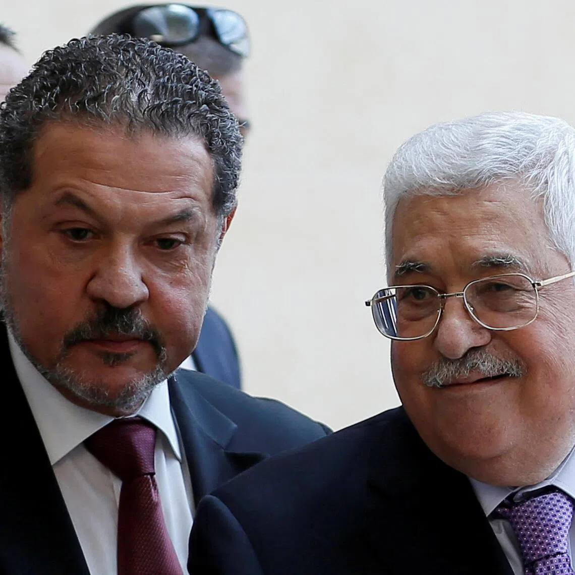 Palestinian President Mahmoud Abbas, accompanied by his son Yasser, leaving a hospital in Ramallah on May 28, 2018.