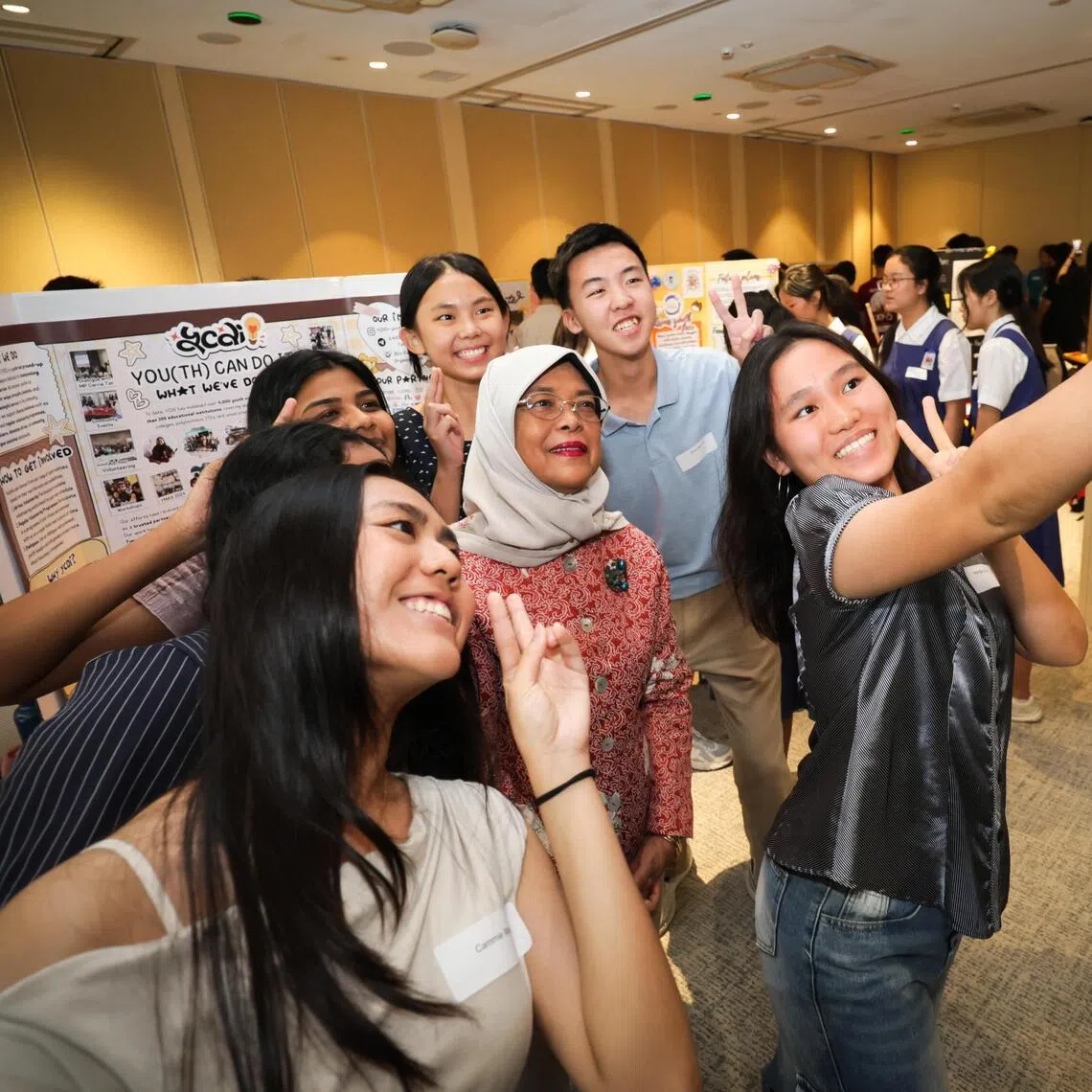 Former president of Singapore Halimah Yacob, who is the Chancellor of the Singapore University of Social Sciences, posing for a wefie at the Festival of Deeds on June 5.