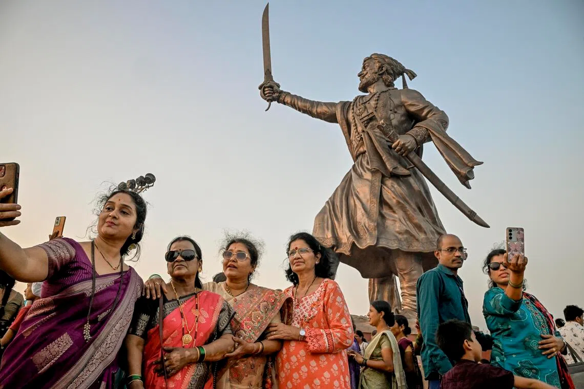 Visitors with the Shivaji statue in Malvan, a small town in Maharashtra, India, in January. There has been a surge of interest in the Hindu warrior in recent years.