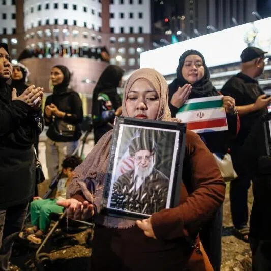Muslim women holding portraits of Iran's late supreme leader Ayatollah Ali Khamenei during a protest outside the US embassy in Kuala Lumpur on March 1.