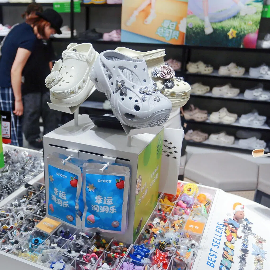 Customers purchase Holey Fashion Shoes in a Crocs store in Shanghai, China on July 3, 2025. 