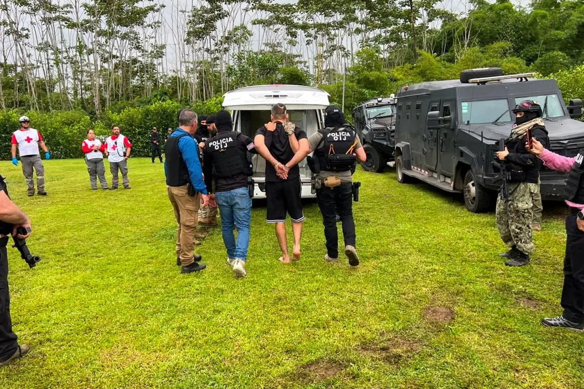 Authorities of Costa Rica's Judicial Investigation Agency (OIJ) escort Alejandro Arias, known as \"El Diablo,\" the Central American country's most wanted fugitive and a suspect sought by the United States on drug trafficking charges, in Alajuela, Costa Rica, in this handout image distributed on July 24, 2026. Judicial Investigation Agency (OIJ)/Handout via REUTERS
