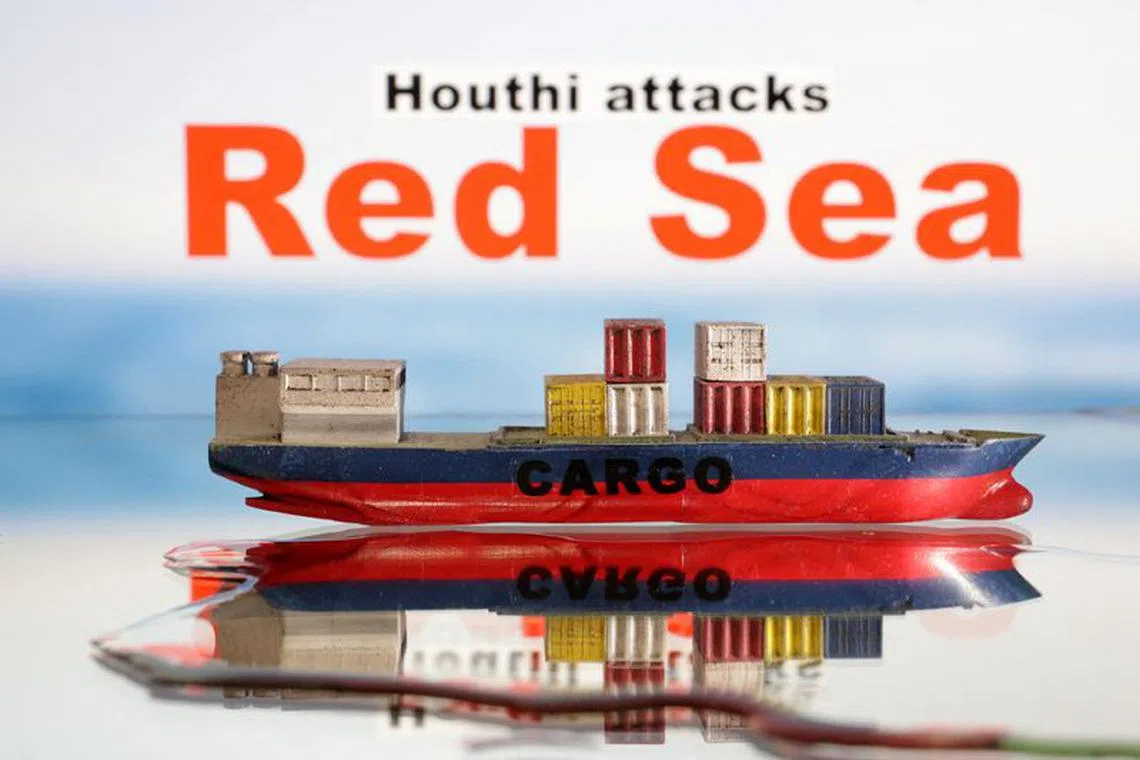 A cargo ship boat model is seen in front of \"Red Sea\" and \"Houthi attacks\" words in this illustration taken January 9, 2024. REUTERS/Dado Ruvic/Illustration