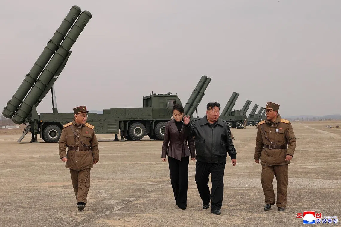 North Korean leader Kim Jong Un, accompanied by his daughter Kim Ju Ae, overseeing the test launch on March 14.