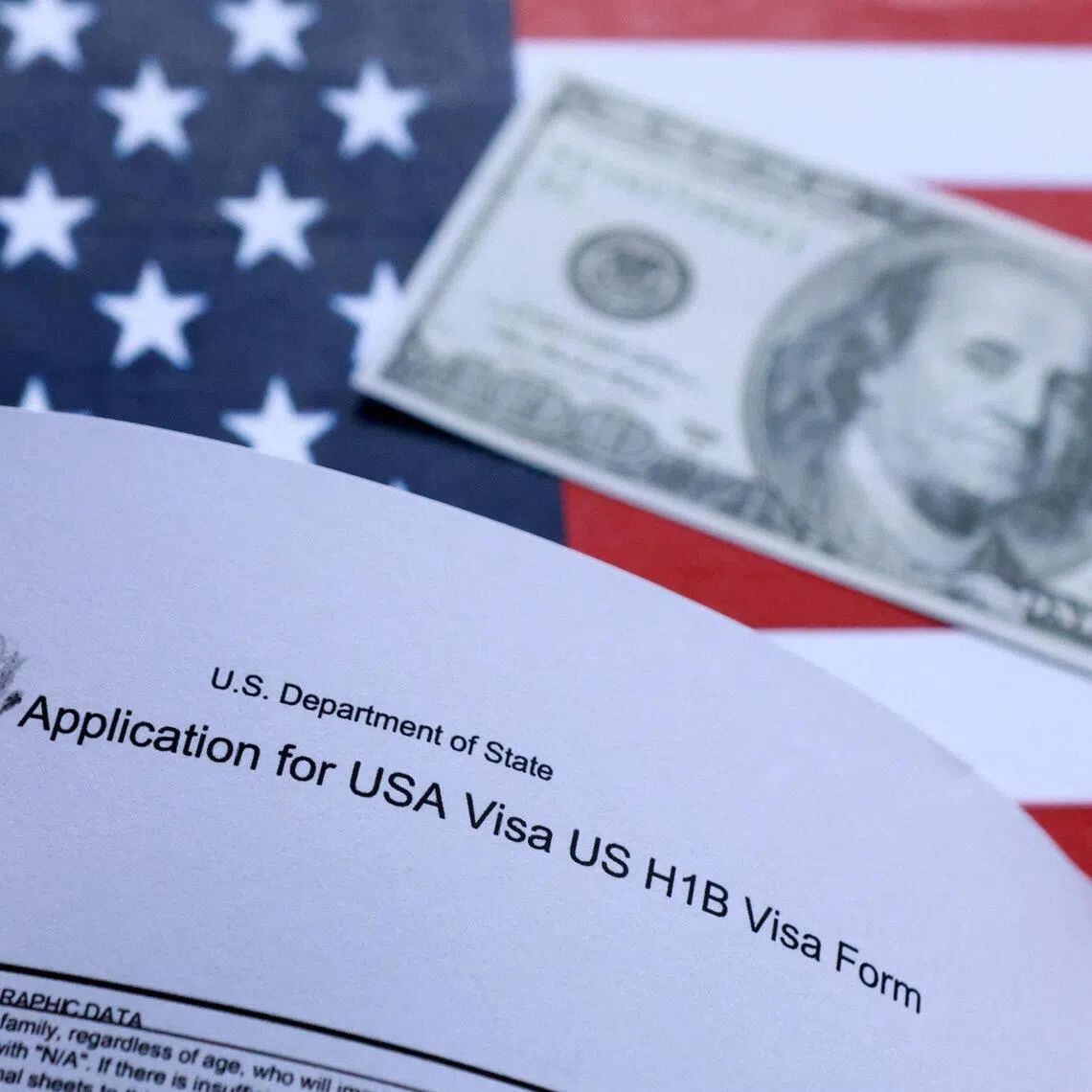 U.S. flag, mock passport, 100 dollar banknote and H-1B visa application form are seen in this illustration taken September 26, 2025. REUTERS/Dado Ruvic/Illustration 