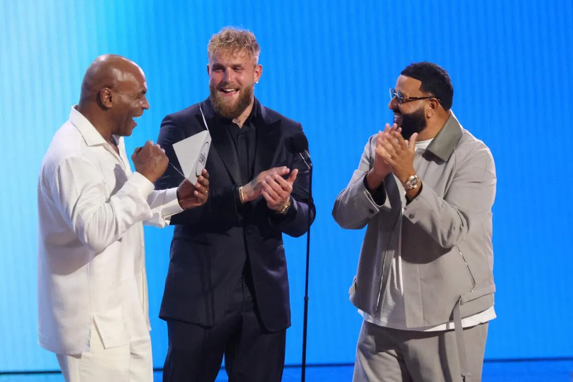 Jake Paul (centre) with legendary boxing champion Mike Tyson (left) and singer DJ Khaled at the ESPY Awards in July.