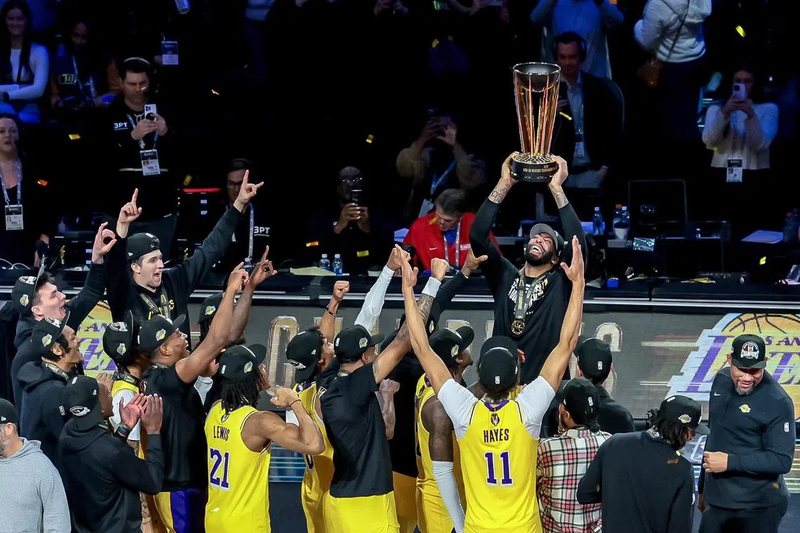 Los Angeles Lakers forward Anthony Davis raising the NBA Cup trophy after defeating the Indiana Pacers in the NBA In-Season Tournament championship final at T-Mobile Arena in Las Vegas, Nevada, on Dec 9.