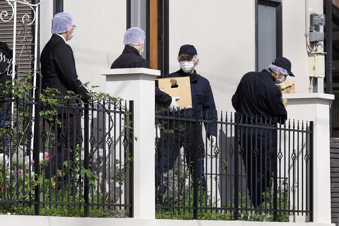 Police officers carry boxes after they searched the house Ryuji Kimura, the man who threw an explosive device at Japanese Prime Minister Fumio Kishida.
