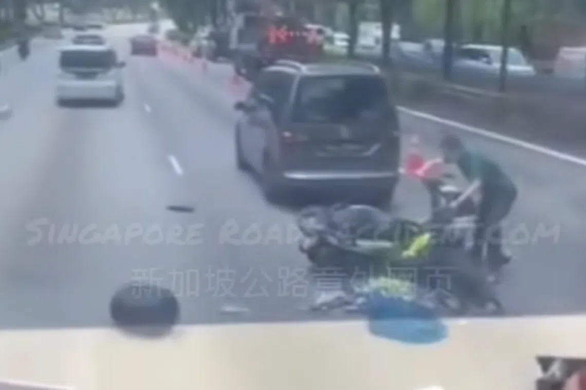 Debris, including a storage box and shattered pieces of the motorcycle’s exterior, is seen scattered across the adjacent lane.