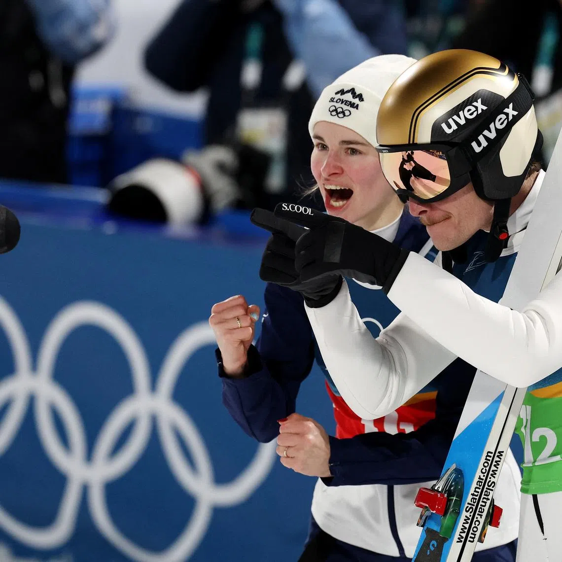 Milano Cortina 2026 Olympics - Ski Jumping - Mixed Team - Predazzo Ski Jumping Stadium, Predazzo, Italy - February 10, 2026. Nika Vodan and Anze Lanisek of Slovenia react after the final round. REUTERS/Kacper Pempel