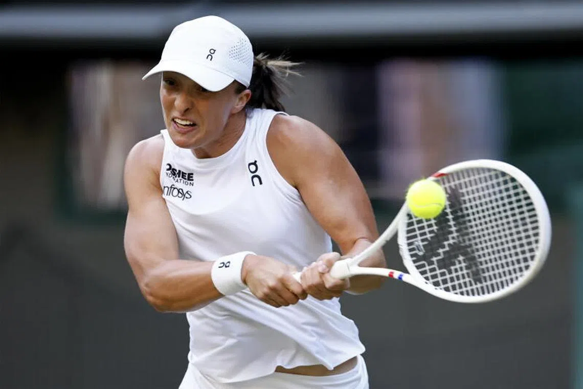 Iga Swiatek of Poland in action during her Women's Singles Round of 16 match against Clara Tauson of Denmark at the Wimbledon Championships.