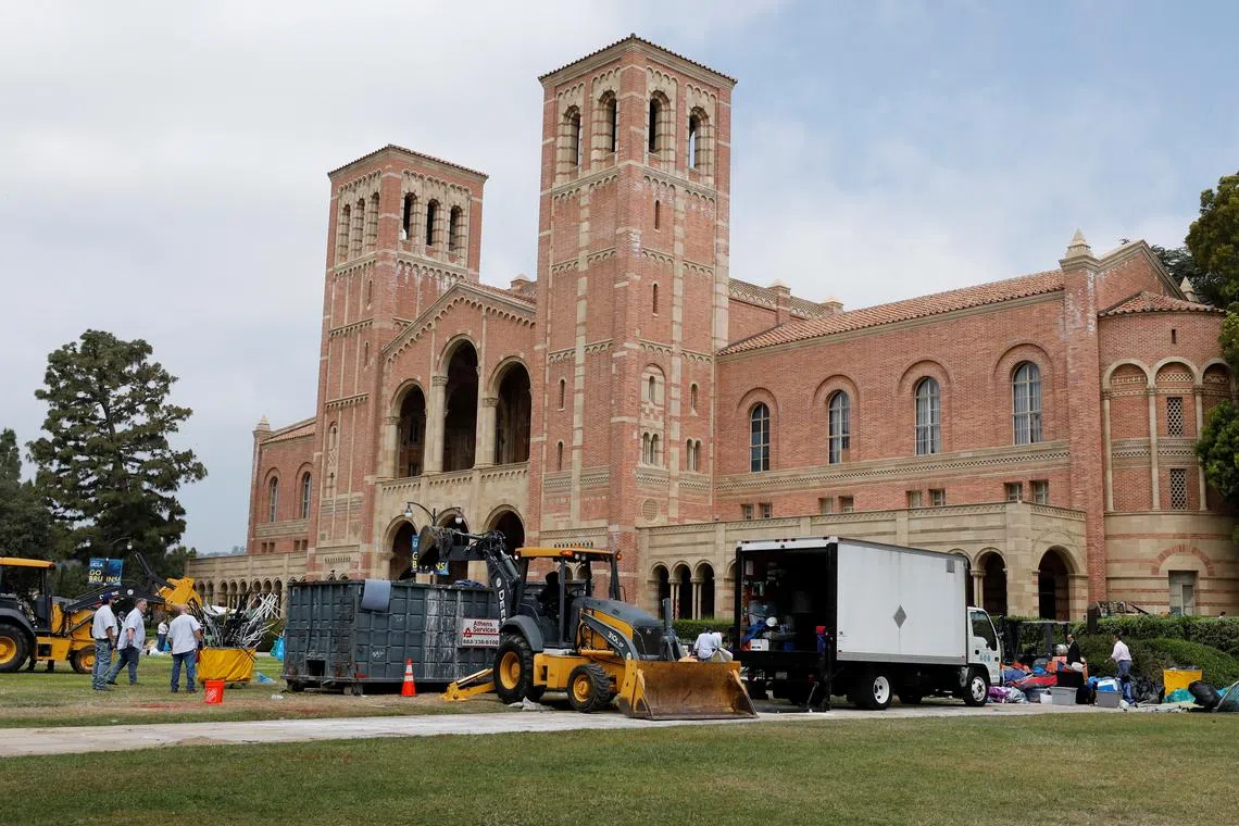 FILE PHOTO: People operating bulldozers remove the remnants of a protest encampment in support of Palestinians, that was broken down by police the previous night on the campus of University of California Los Angeles (UCLA), in Los Angeles, California, U.S., May 2, 2024. REUTERS/Carlin Stiehl/File Photo