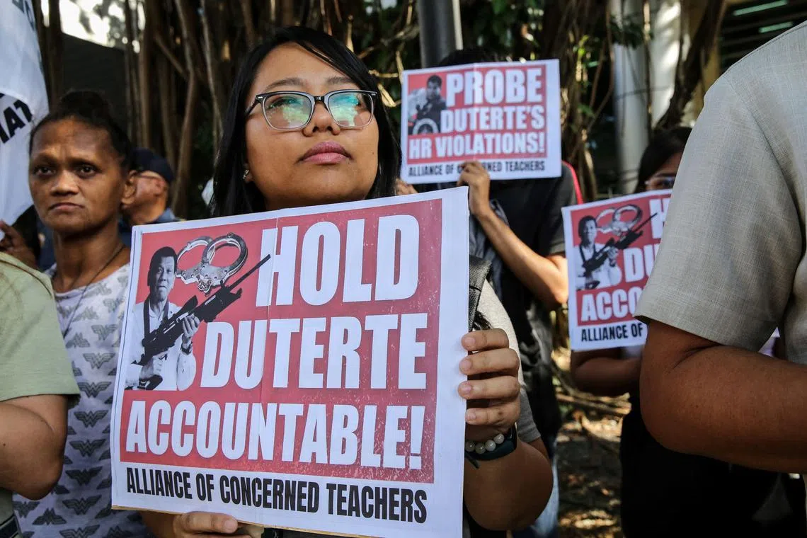 Supporters of Philippine lawmaker France Castro hold a noise barrage before the preliminary investigation of her grave threat complaint filed against former Philippine President Rodrigo Duterte outside the Prosecutor’s Office in Quezon City, Metro Manila on December 4, 2023. (Photo by Earvin Perias / AFP)