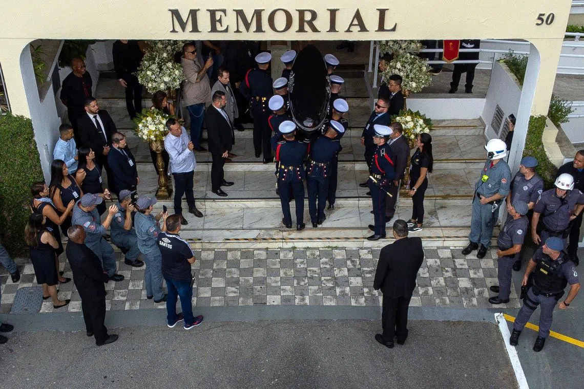 The casket of the late Brazilian football star Pele is carried to the Santos' Memorial Cemetery after the funeral procession in Santos, Brazil, on Jan 3, 2023.