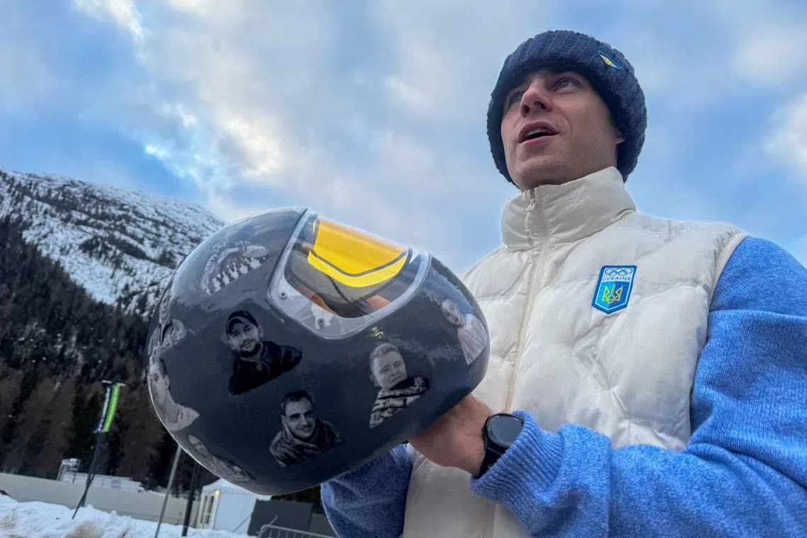 Ukrainian skeleton athlete Vladyslav Heraskevych holds his helmet with images of compatriots killed during the war in Ukraine, at the Milano Cortina Gamesin in Cortina D'Ampezzo, Italy, February 9, 2026. REUTERS/Cristiano Corvino