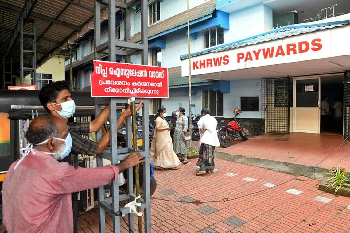 FILE PHOTO: Staff members install a sign reading &quot;Nipah isolation ward, entry strictly prohibited&quot; at a hospital where a ward is being prepared for suspected Nipah virus patients in Kozhikode district, Kerala, India, September 12, 2023. REUTERS/Stringer/File Photo