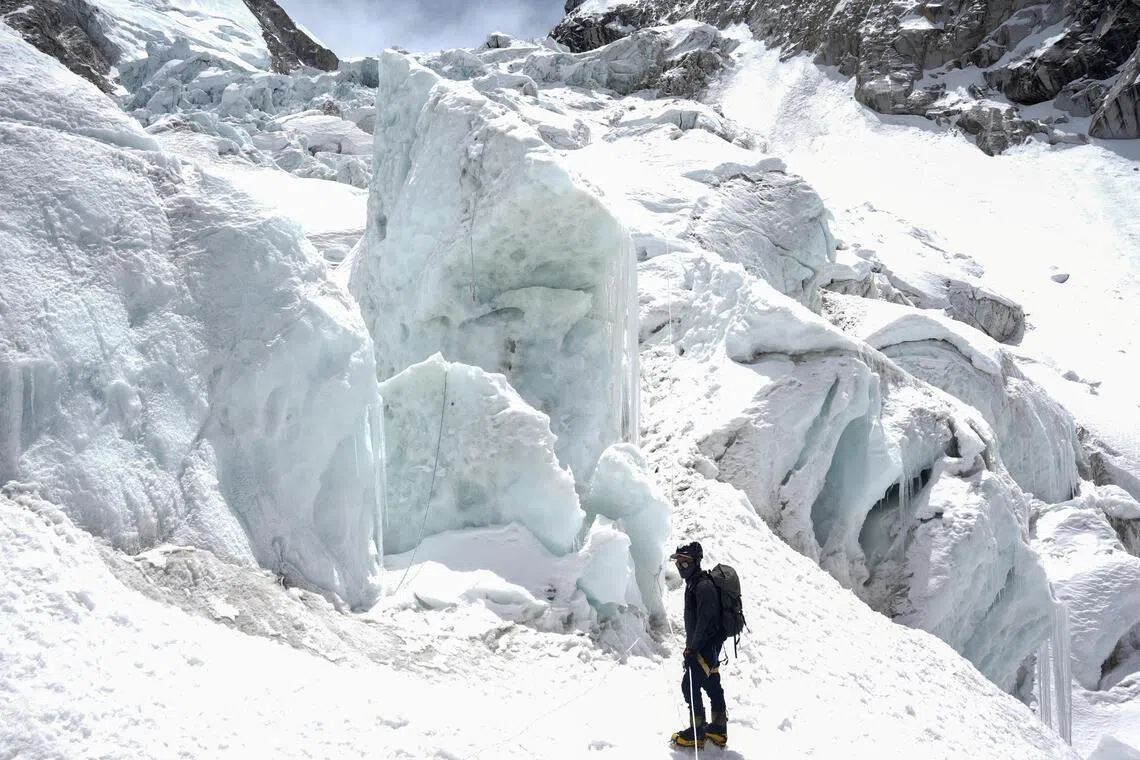 A member of expedition team stands at Khumbu Icefall, as the route to Mount Everest Camp One has not yet been opened for the season in Solukhumbu district, also known as the Everest region, Nepal, April 22, 2026. REUTERS/Purnima Shrestha