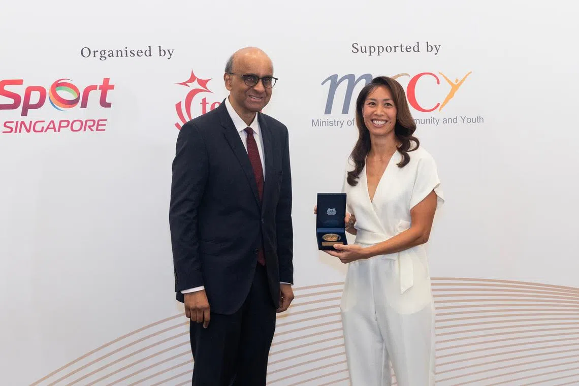 Most bemedalled SEA Games swimmer Joscelin Yeo (right) received her award from President Tharman Shanmugaratnam.