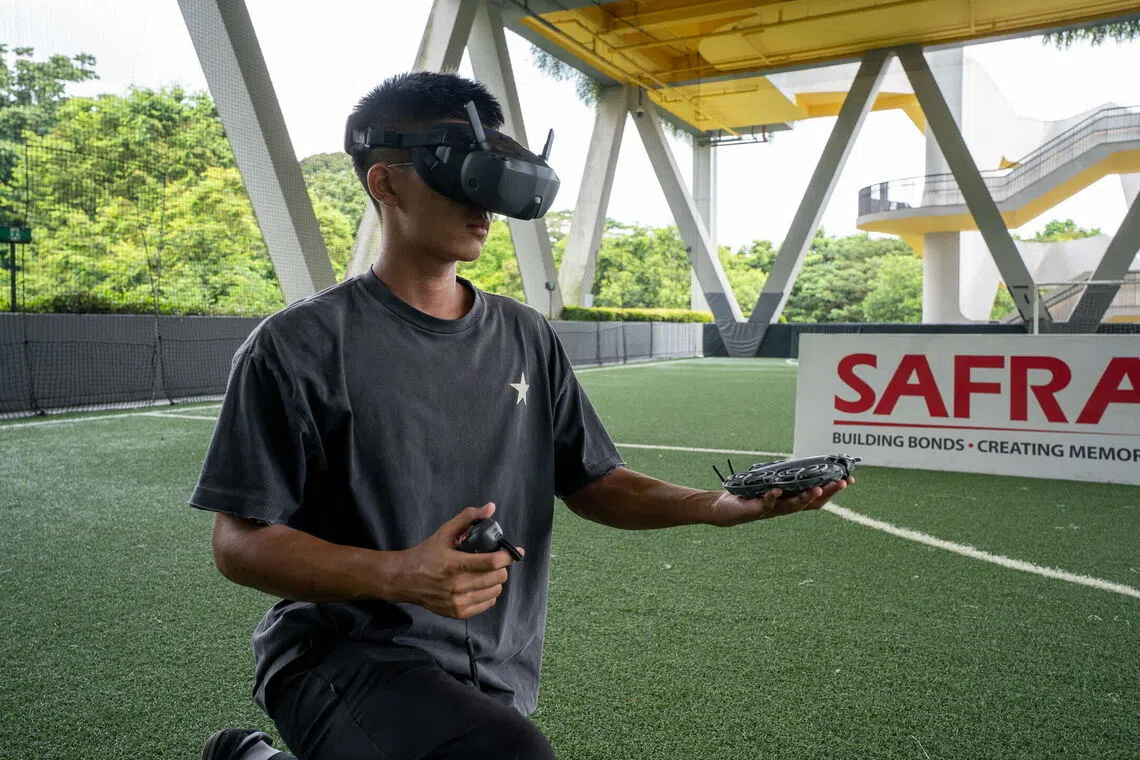 An NSman testing a drone at SAFRA Choa Chu Kang.