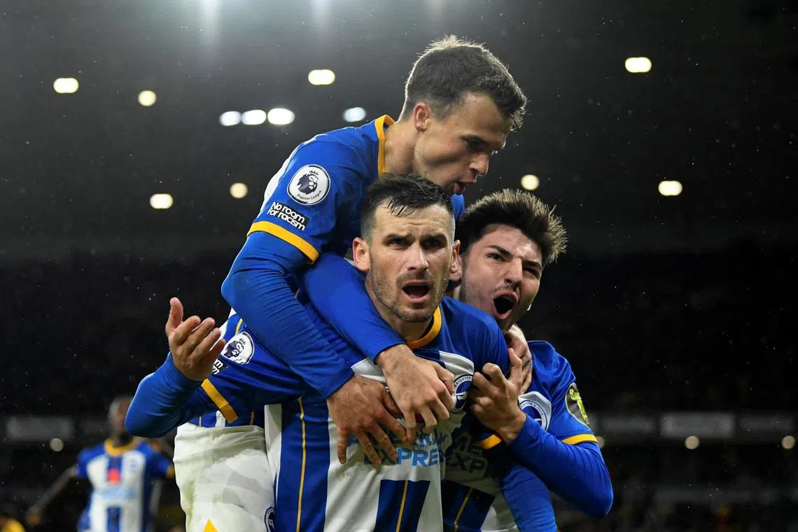 Brighton's Pascal Gross celebrates scoring their third goal with Solly March and Billy Gilmour.