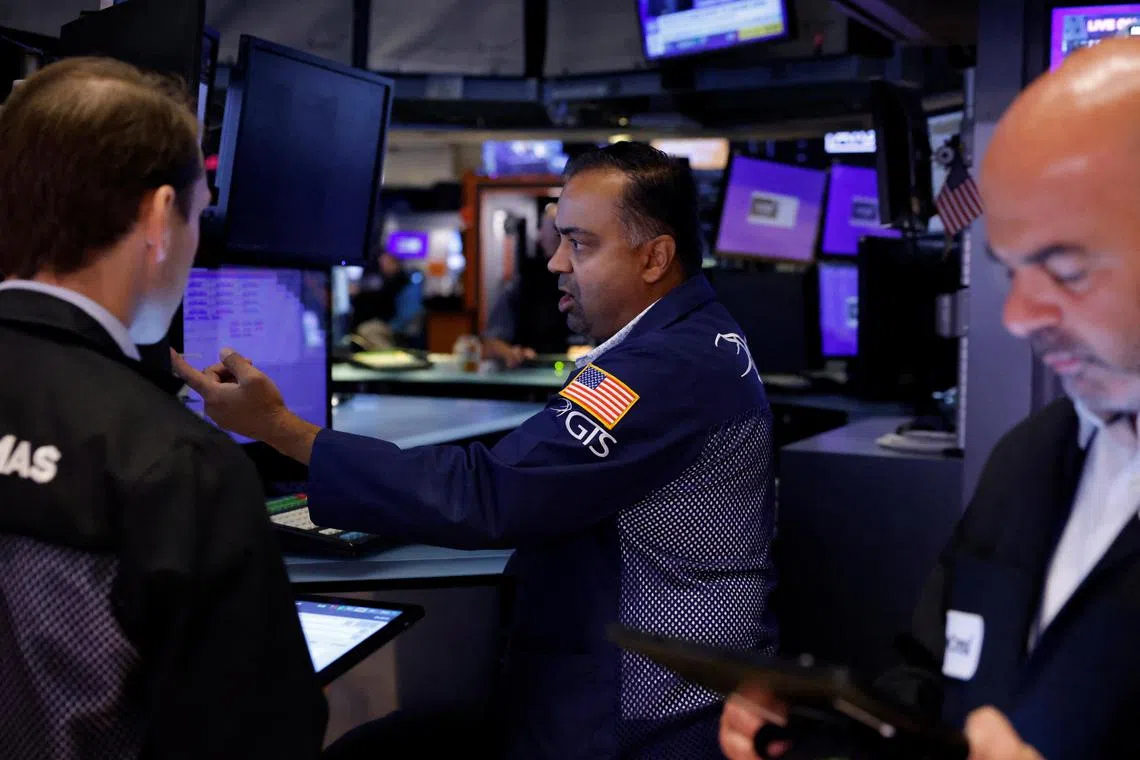 Traders work on the floor of the New York Stock Exchange, in New York City.