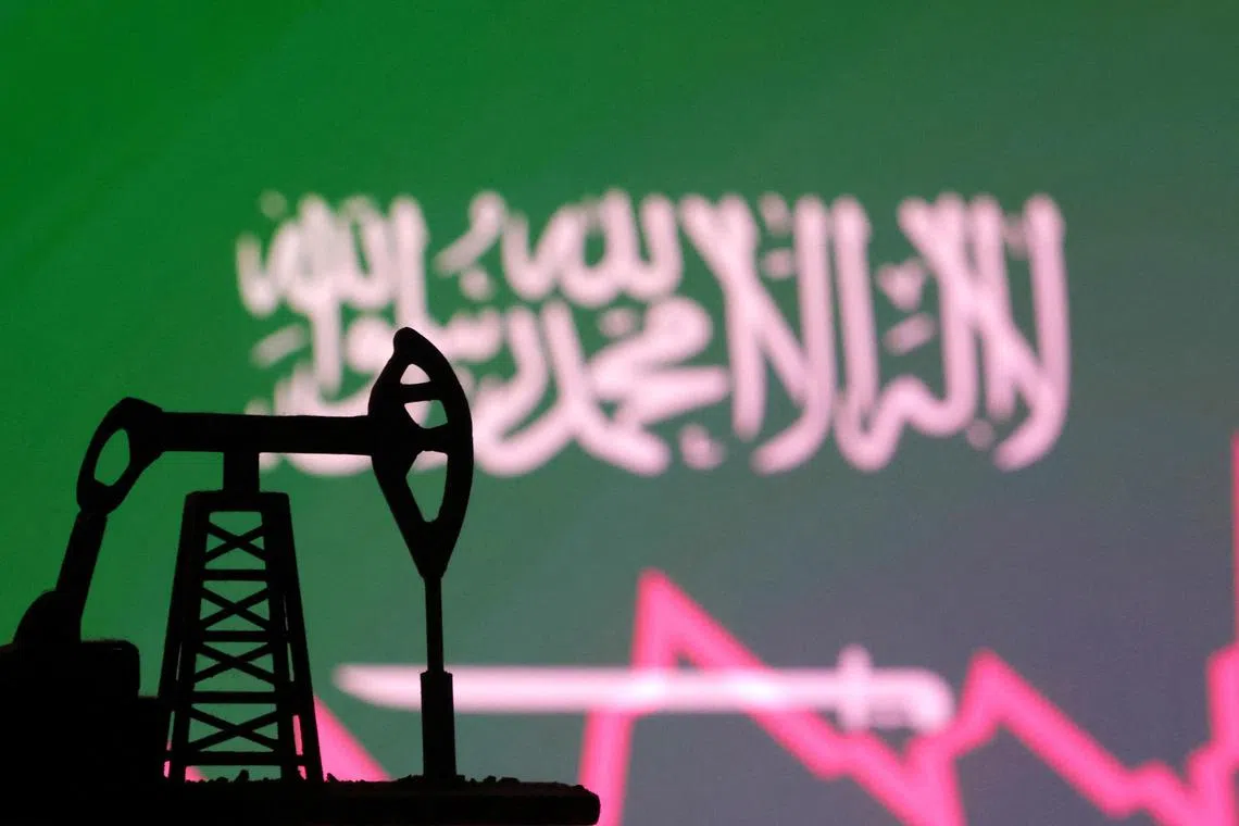 Saudi Arabian flag with stock graph and an oil pump jack miniature model are seen in this illustration taken October 9, 2023. REUTERS/Dado Ruvic/Illustration