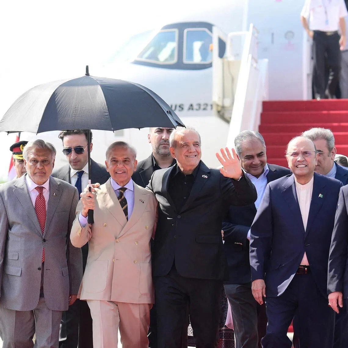 Iranian President Masoud Pezeshkian waving as he is welcomed to Pakistan on June 23 by Prime Minister Shehbaz Sharif and President Asif Ali Zardari.