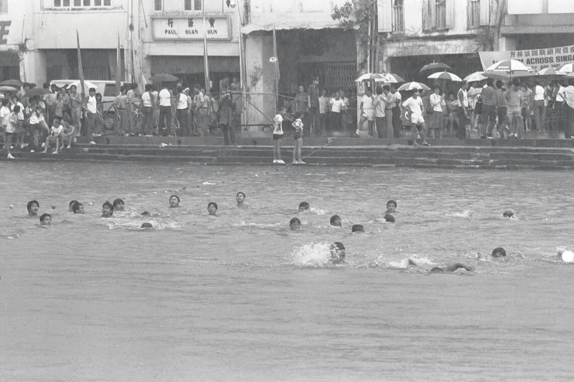 Participants taking part in a mass swim across the Singapore River organised by the Hong Lim Green community centre.