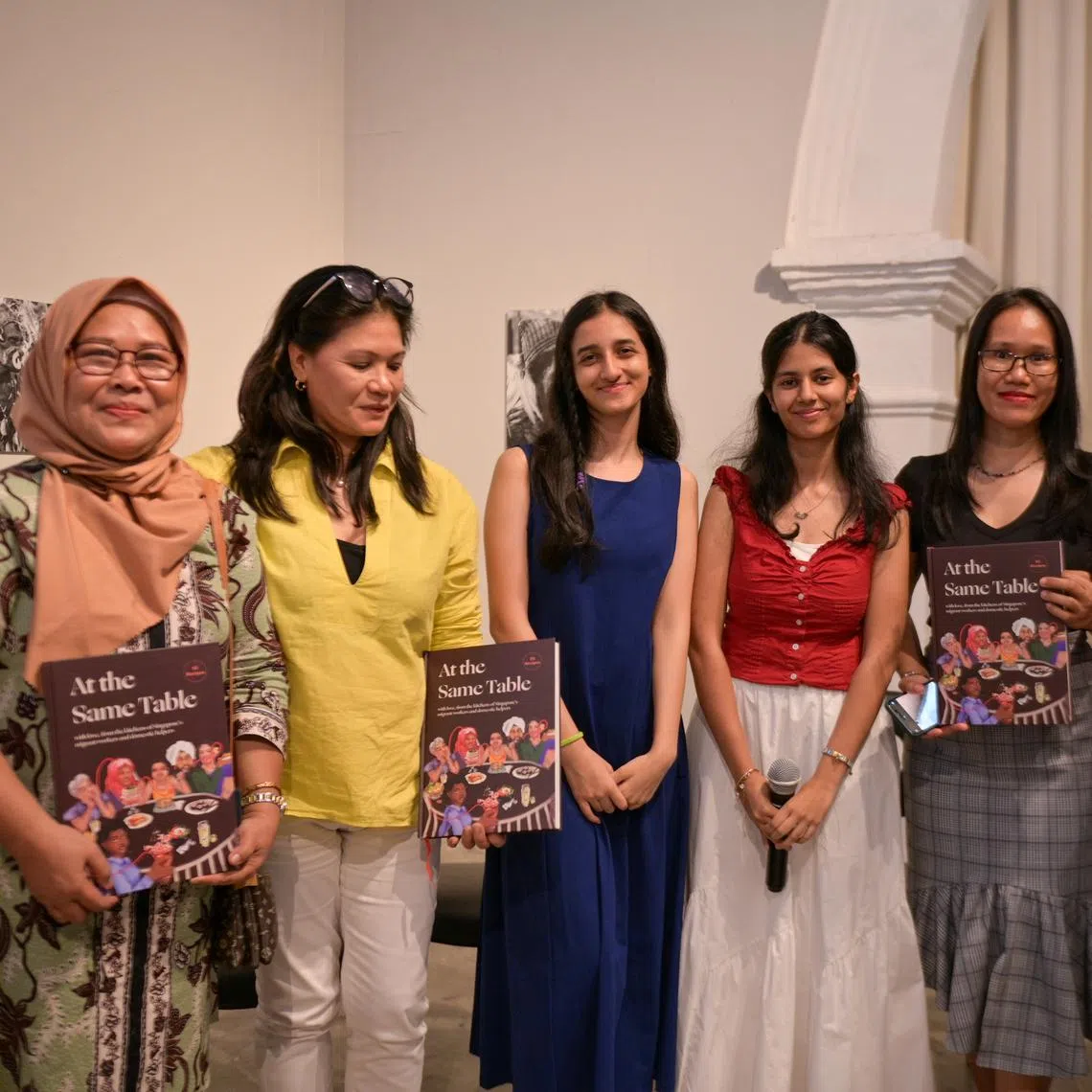 At The Same Table project leaders Tanya Arora (third from left) and Aahana Mittal (fourth from left) with some of the cooks featured in the cookbook.