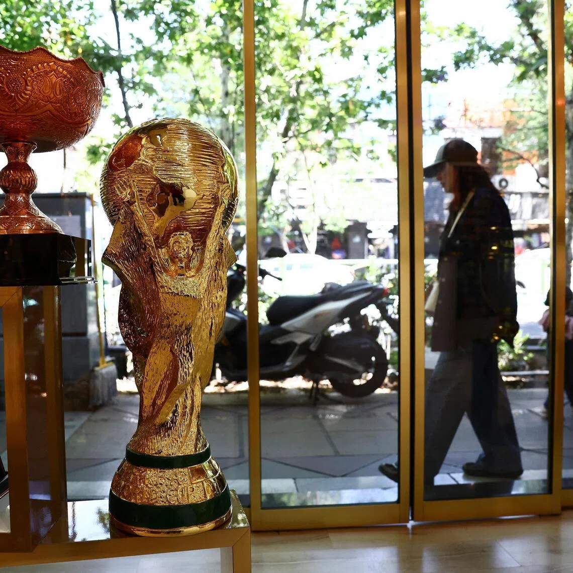 A replica of the FIFA World Cup trophy is displayed in a shop, in Tehran, Iran.