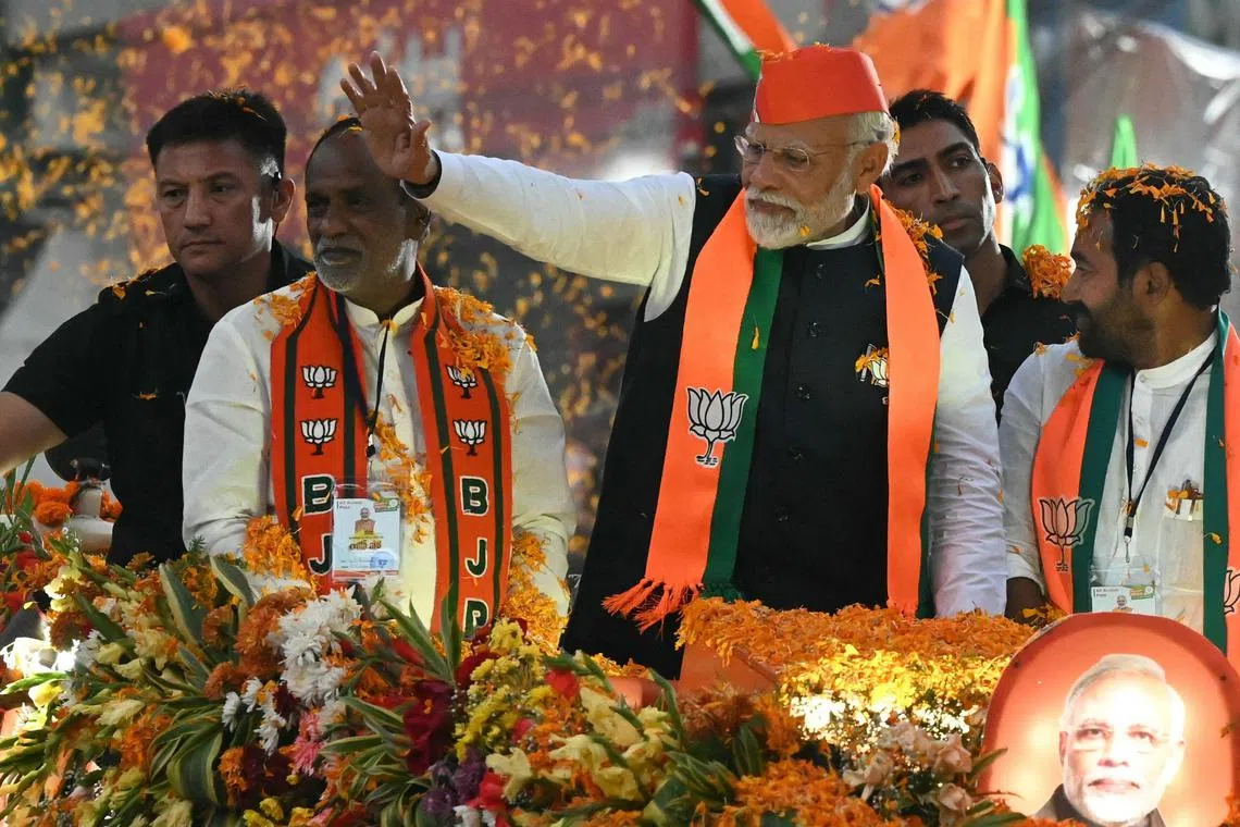 India’s Prime Minister Narendra Modi waves to supporters as part of Bharatiya Janata Party’s (BJP) election campaign on Nov 27 ahead of the Telangana state assembly elections.