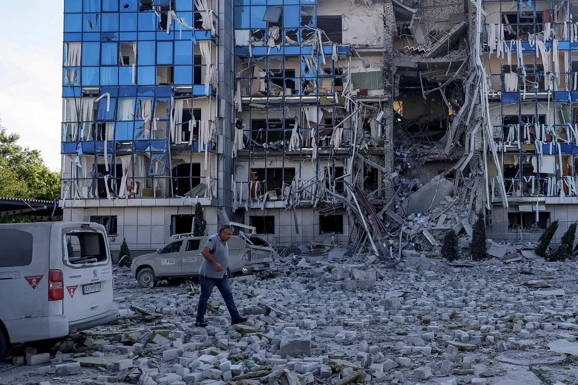 FILE PHOTO: A man walks next to an office building of FSD (Fondation Suisse de Déminage), a non-governmental humanitarian organisation, damaged during a Russian missile attack, amid Russia's attack on Ukraine, in Kharkiv, Ukraine July 24, 2024. REUTERS/Vyacheslav Madiyevskyy/File Photo