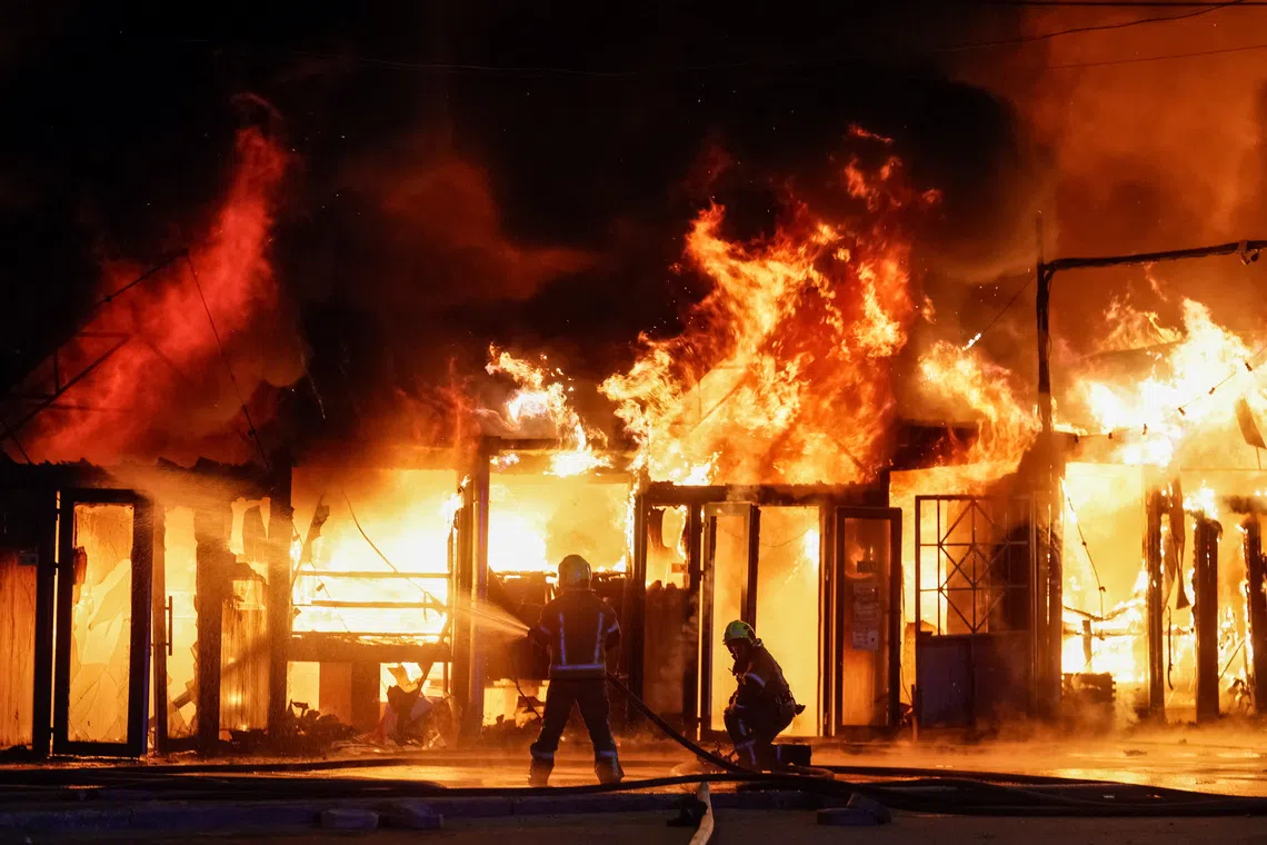 Firefighters work at a site of a book market hit by a Russian missile strike, amid Russia's attack on Ukraine, in Kyiv region, Ukraine August 16, 2026. REUTERS/Gleb Garanich