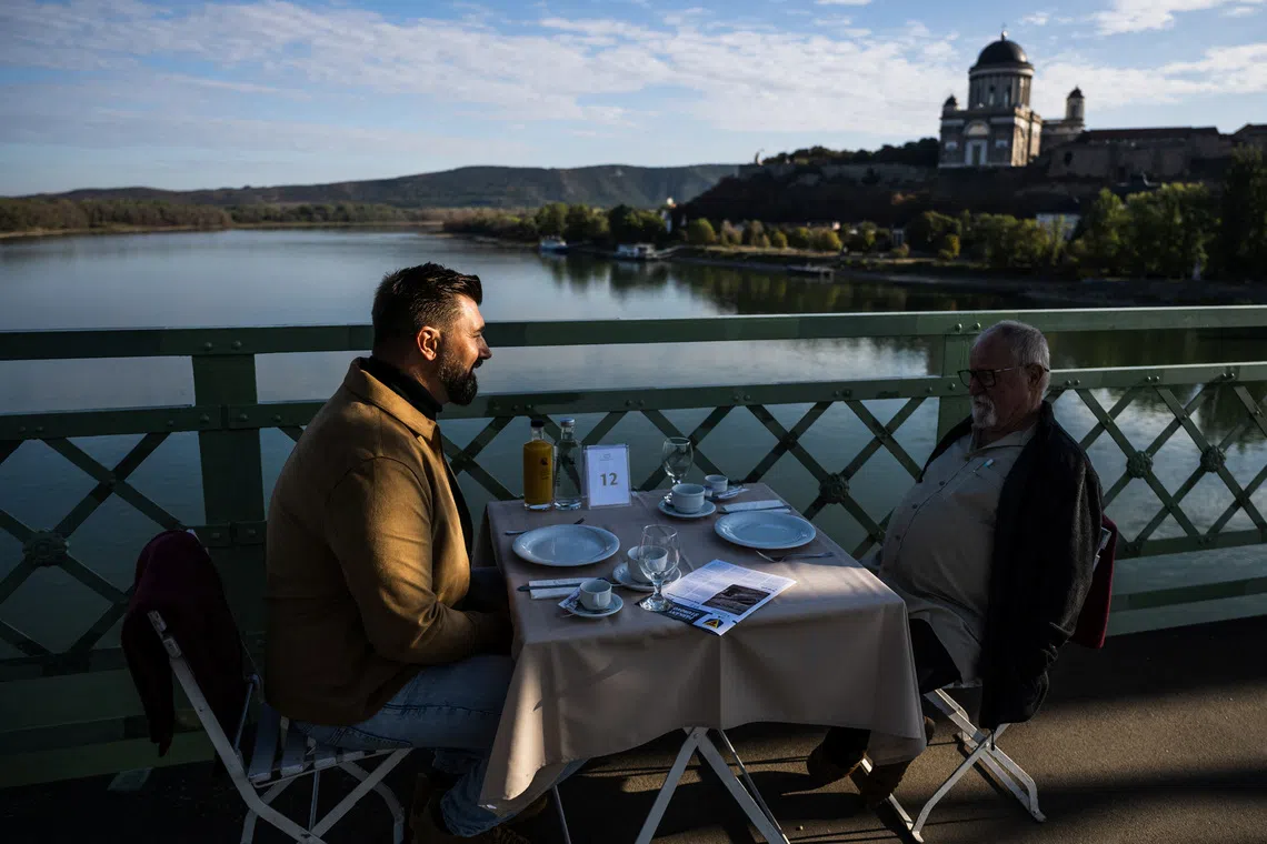 Hungarians and Slovaks share breakfast on Danube bridge that survived war and division