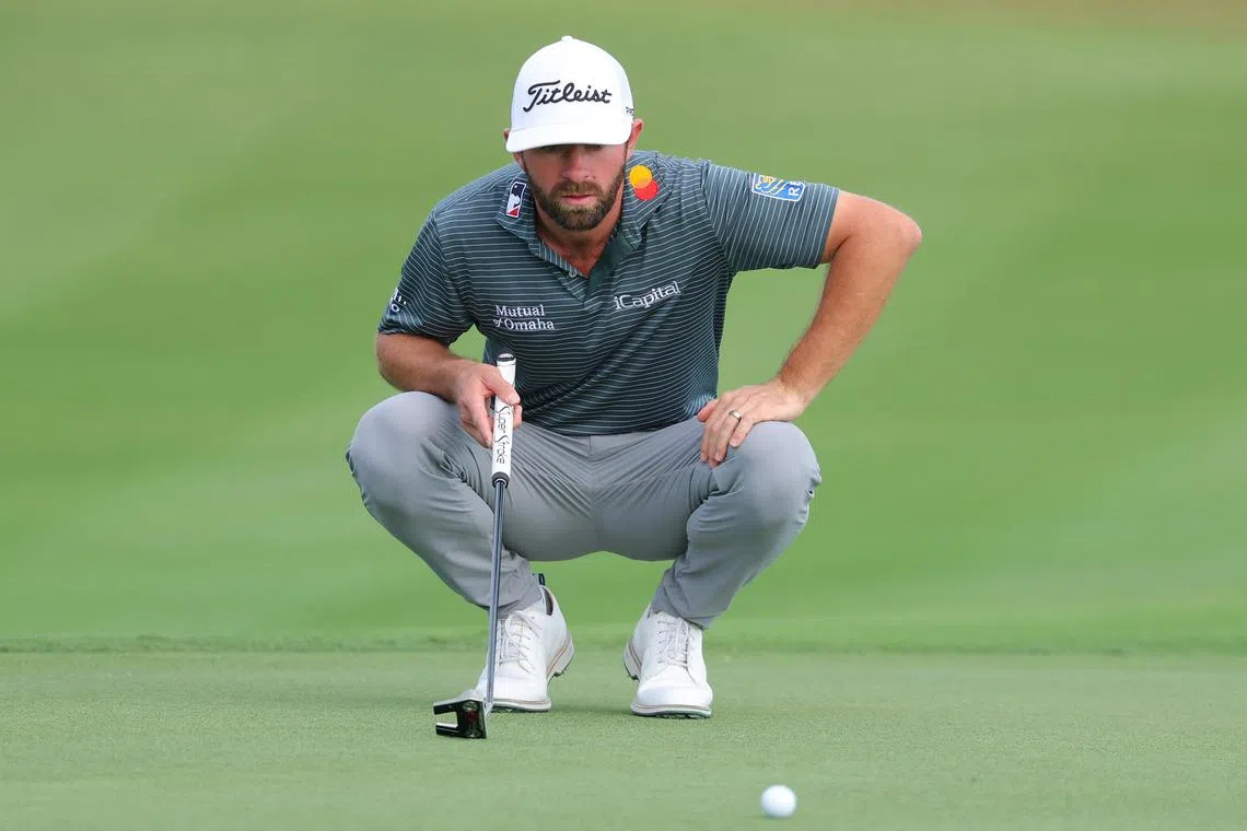 Cameron Young of the United States lines up a putt on the 18th green during the first round of the Hero World Challenge.