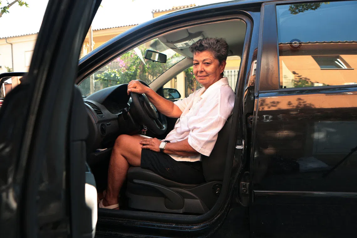 Pilar Lopez poses inside the car where she slept for two months after she was evicted this summer from the apartment where she had lived for 12 years, in Palma de Mallorca, Spain, September 27, 2026. REUTERS/Francisco Ubilla