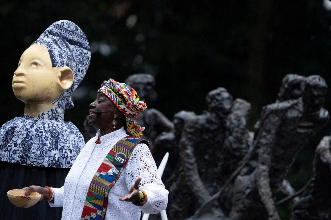 FILE PHOTO: Winti priest Marian Markelo carries out a libation at the slavery monument prior to a speech by Dutch King Willem-Alexander in which apologised for the royal house's role in slavery and asked for forgiveness at an event to commemorate the anniversary of the abolition of slavery by the Netherlands, in Amsterdam, Netherlands, Saturday, July 1, 2023. Peter Dejong/Pool via REUTERS/File Photo