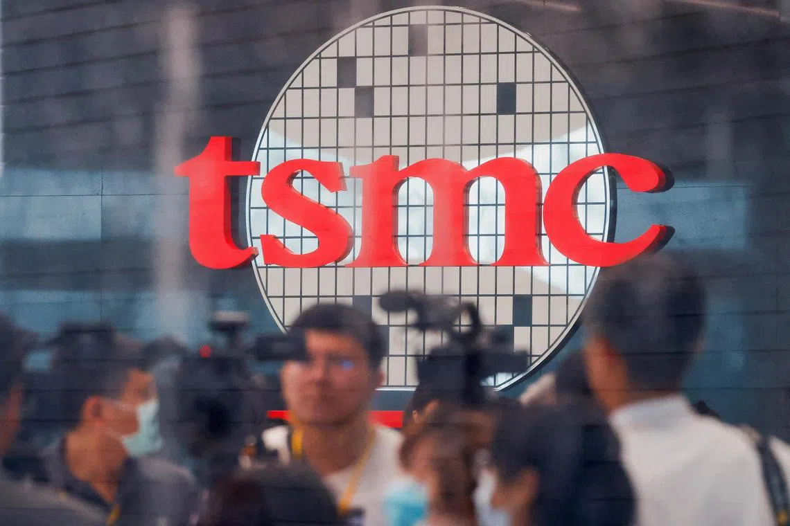 FILE PHOTO: Taiwan Semiconductor Manufacturing Co's logo is seen while people attend the opening of the TSMC global R&D centre in Hsinchu, Taiwan, July 28, 2023. REUTERS/Ann Wang/File Photo
